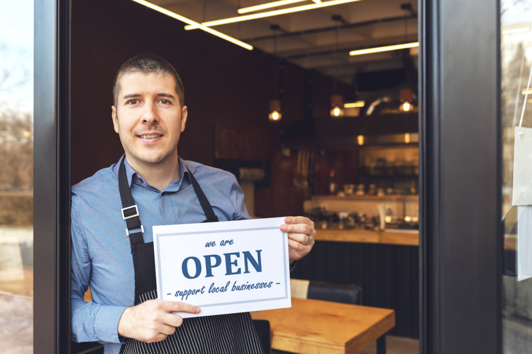 Gentleman holds open for business sign